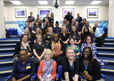 A group of staff members smiling for a photo at the Hospital at Home launch event