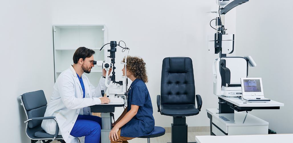 Male doctor conducting an eye test on a female patient