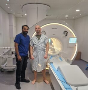 Krzystof Didek pictured in front of a MRI scanner after the first MRI scan at Wood Green Community Diagnostic Centre.