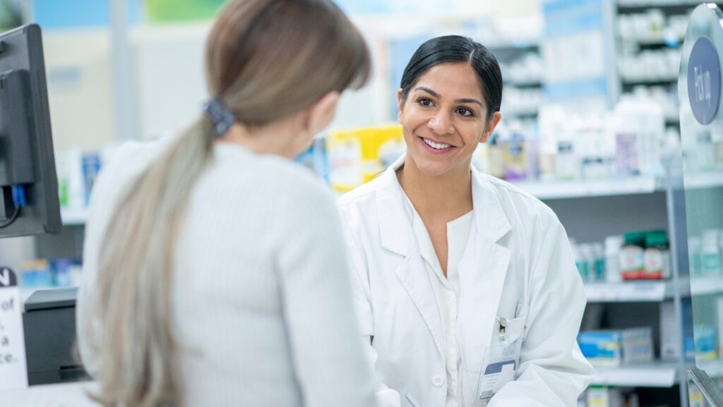 A pharmacist speaking to a patient