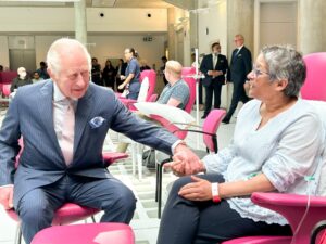 King Charles III sat down with patient in hospital setting