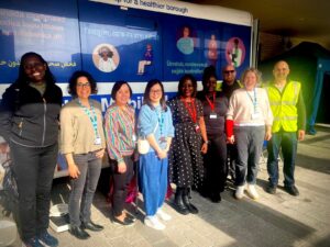 Staff stand in front of Health and Wellbeing Bus including Louise Keane, second from right