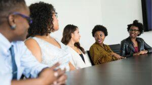 Group of people standing and talking in an office